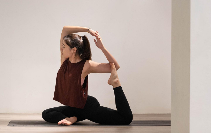 Woman doing yoga pose on yoga mat