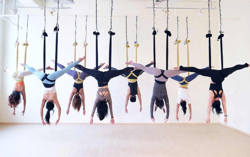 Back view of women doing aerial yoga at Hale yoga