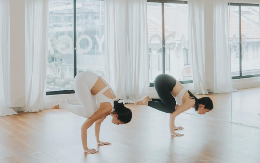 Yoga practitioners balancing on their hands in a studio