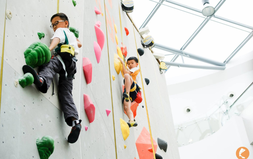 2 boys doing rock climbing at Climb Central