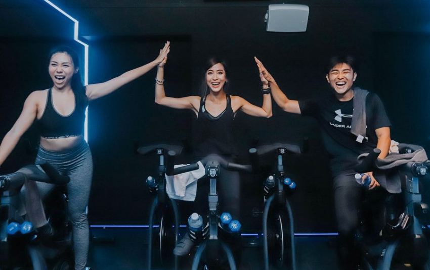 Riders having fun during a spin class at Revolution
