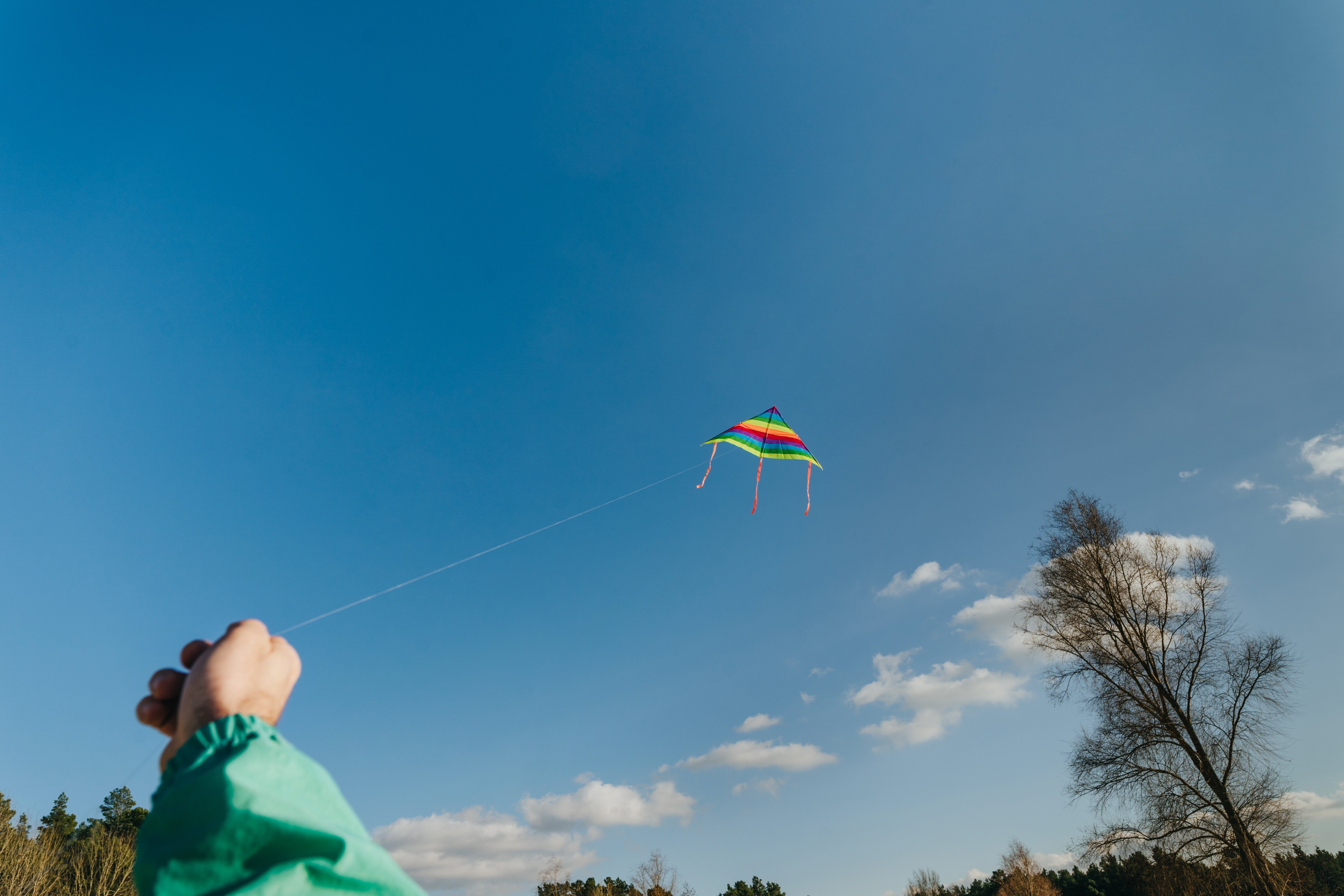 colorful-kite-flying-in-the-blue-sky-2021-12-08-18-50-09-utc