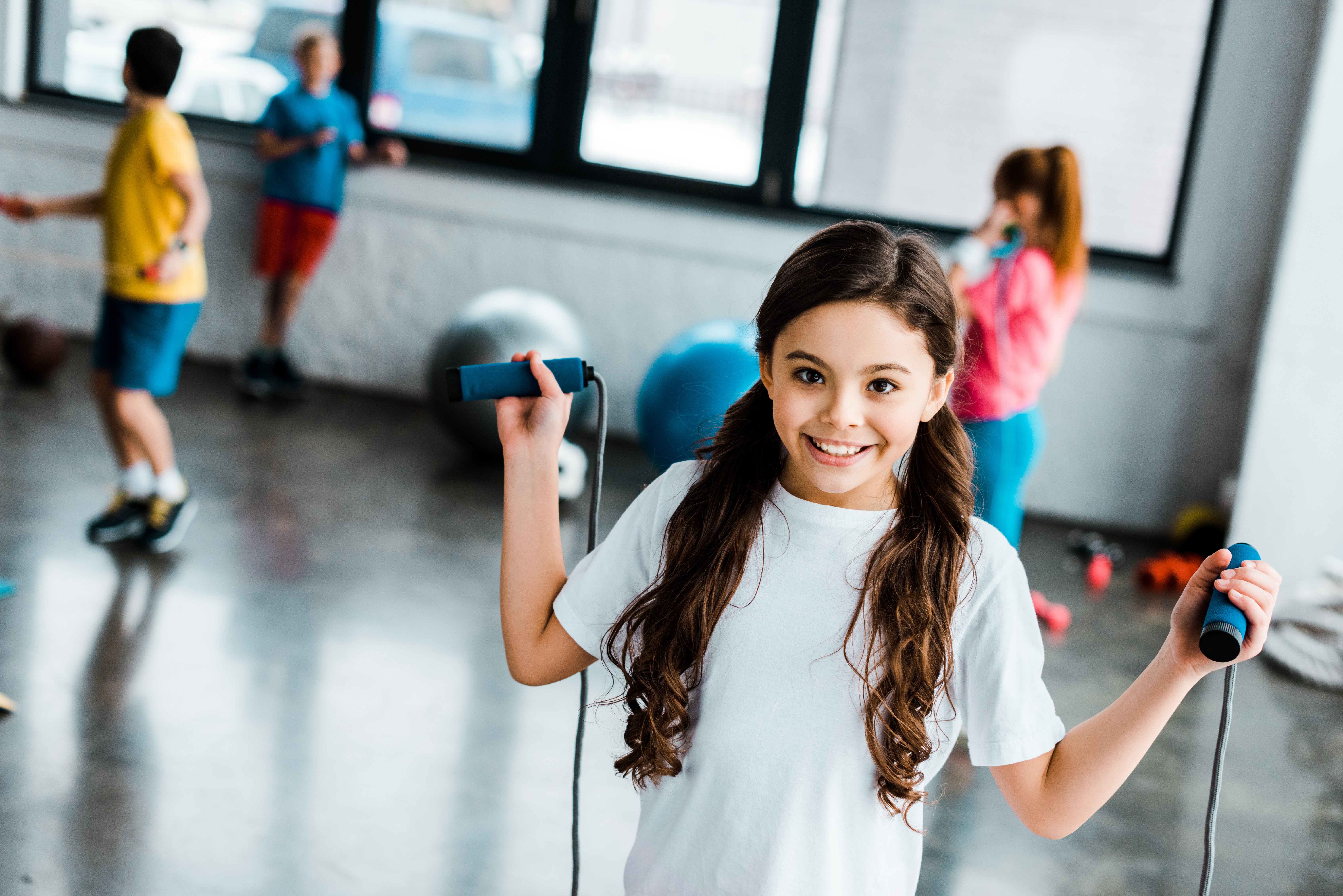 playful-child-posing-in-gym-with-skipping-rope-2021-09-15-00-50-59-utc